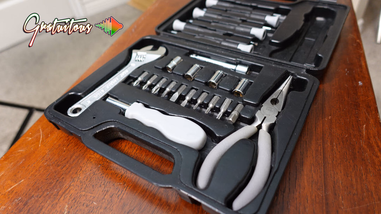Small Tool Kit Set Showing Pliers, a Wrench, Multi-Screw Driver, and Socket Set Attachments